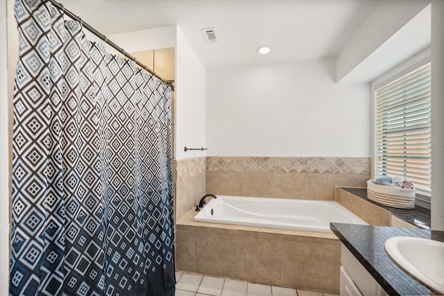 5603 Farris Dr, Arlington, TX 76017 - bathroom featuring tile patterned flooring, vanity, a garden tub, and a shower with shower curtain