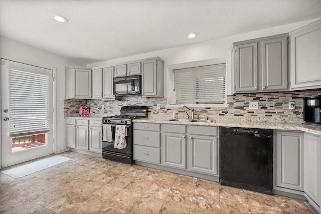 5603 Farris Dr, Arlington, TX 76017 - kitchen with black appliances, gray cabinetry, backsplash, light stone counters, and recessed lighting
