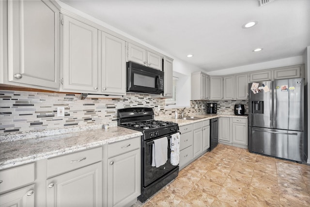 5603 Farris Dr, Arlington, TX 76017 - kitchen featuring black appliances, decorative backsplash, recessed lighting, light stone counters, and gray cabinets