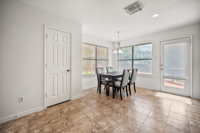 5603 Farris Dr, Arlington, TX 76017 - dining area with a chandelier and a textured wall