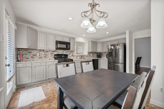 5603 Farris Dr, Arlington, TX 76017 - kitchen featuring black appliances, a chandelier, tasteful backsplash, light countertops, and gray cabinets
