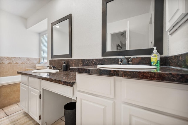 5603 Farris Dr, Arlington, TX 76017 - full bathroom featuring double vanity, tile patterned floors, and tiled tub