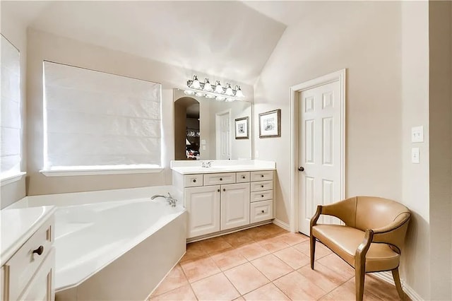 946 Briar Oaks Dr, Rockwall, TX 75087 - full bath featuring vanity, a garden tub, vaulted ceiling, and tile patterned flooring