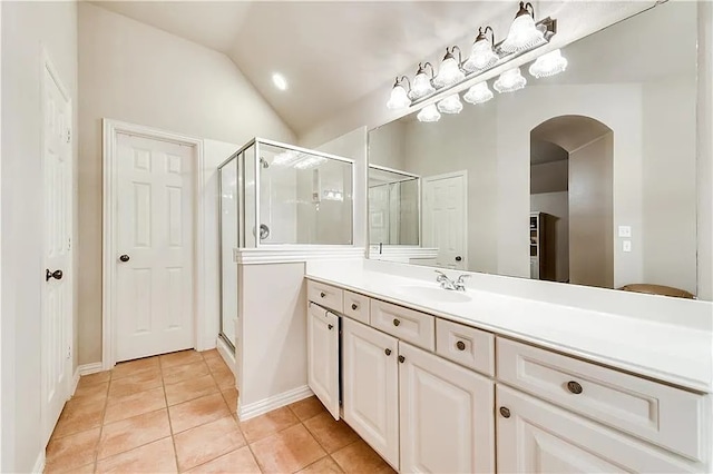 946 Briar Oaks Dr, Rockwall, TX 75087 - bathroom with vanity, lofted ceiling, tile patterned flooring, and a stall shower