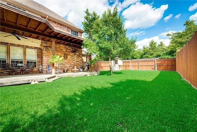 946 Briar Oaks Dr, Rockwall, TX 75087 - fenced backyard featuring a ceiling fan and a patio