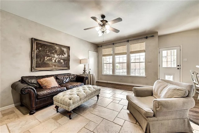 946 Briar Oaks Dr, Rockwall, TX 75087 - living area featuring healthy amount of natural light, ceiling fan, and stone tile flooring