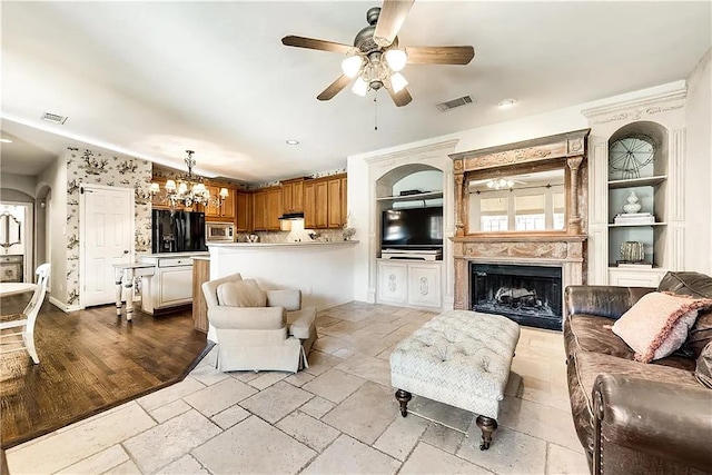 946 Briar Oaks Dr, Rockwall, TX 75087 - living room featuring ceiling fan, a fireplace, stone tile flooring, built in shelves, and recessed lighting