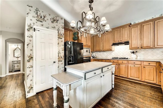 946 Briar Oaks Dr, Rockwall, TX 75087 - kitchen with black appliances, a kitchen island, dark wood finished floors, light countertops, and vaulted ceiling