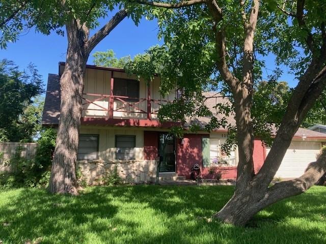 121 Wake Dr, Richardson, TX 75081 - view of property hidden behind natural elements with a front lawn, a balcony, and stone siding