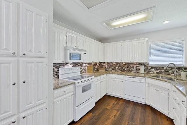 3937 Marsh Ln, Fort Worth, TX 76123 - kitchen featuring white appliances, tasteful backsplash, dark wood-type flooring, light stone countertops, and white cabinetry