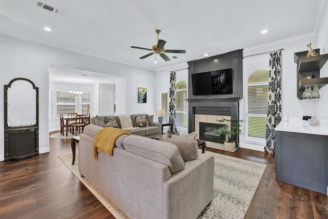 3937 Marsh Ln, Fort Worth, TX 76123 - living room with a ceiling fan, plenty of natural light, a large fireplace, dark wood finished floors, and crown molding
