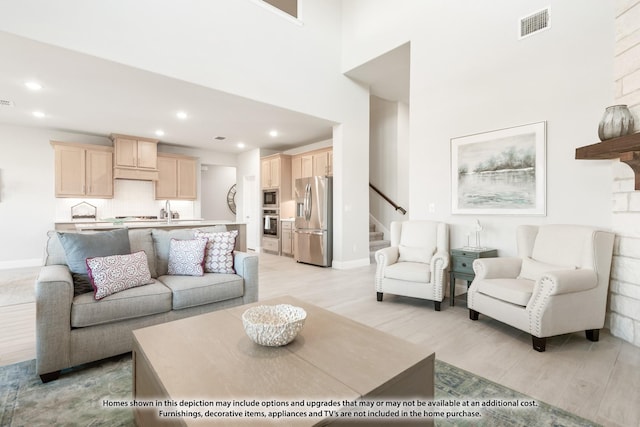443 Aspen Way, Lavon, TX 75166 - living area with light wood finished floors, recessed lighting, stairway, and a high ceiling