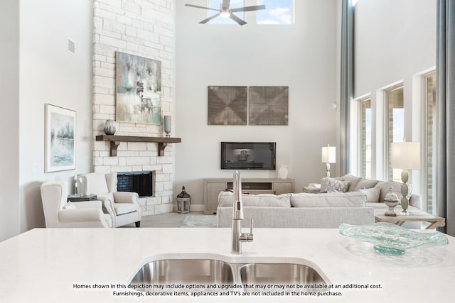 443 Aspen Way, Lavon, TX 75166 - living room featuring a towering ceiling, ceiling fan, and a stone fireplace