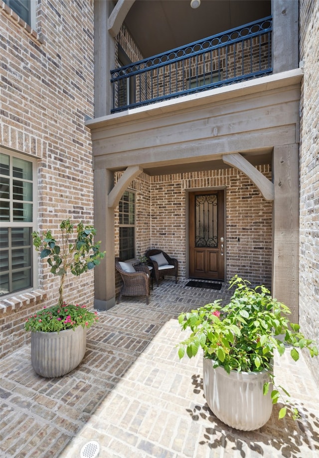 2751 Langley Way, Prosper, TX 75078 - property entrance featuring a balcony, brick siding, and a patio