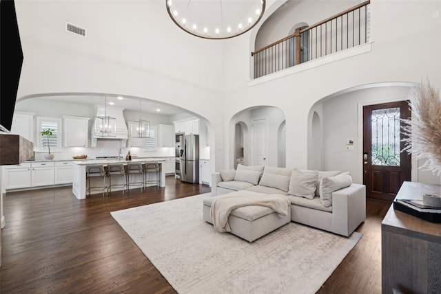 2751 Langley Way, Prosper, TX 75078 - living room featuring a chandelier, dark wood-type flooring, a high ceiling, and recessed lighting