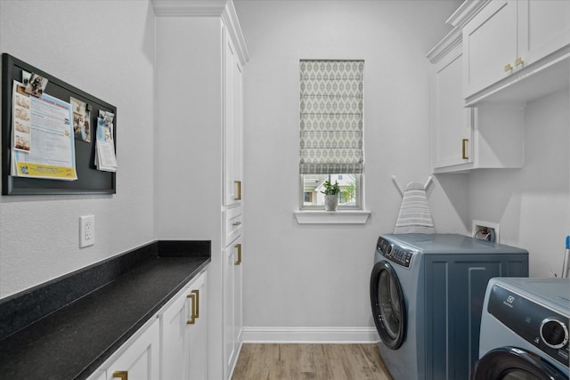 12457 Maplewood Dr, Lindale, TX 75771 - laundry room featuring separate washer and dryer, light wood-style flooring, and cabinet space