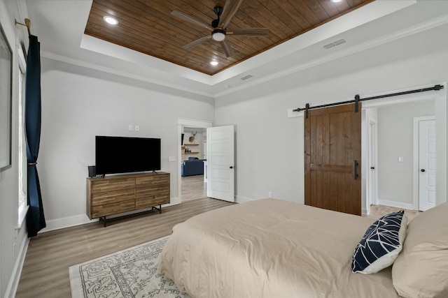12457 Maplewood Dr, Lindale, TX 75771 - bedroom with a tray ceiling, wooden ceiling, a barn door, wood finished floors, and recessed lighting