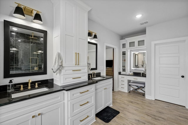 12457 Maplewood Dr, Lindale, TX 75771 - bathroom with double vanity, a shower stall, and wood finished floors