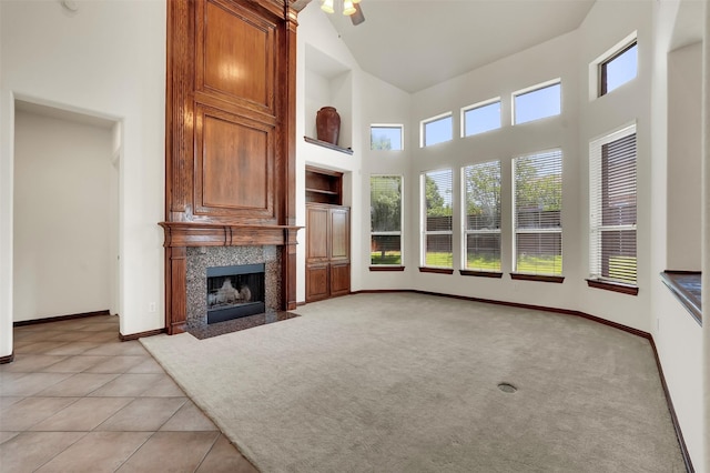 1910 Saint Johns Ave, Allen, TX 75002 - unfurnished living room with high vaulted ceiling, a premium fireplace, ceiling fan, light tile patterned floors, and built in features
