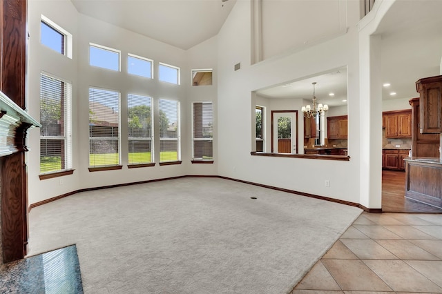 1910 Saint Johns Ave, Allen, TX 75002 - unfurnished living room with healthy amount of natural light, a chandelier, light tile patterned floors, light colored carpet, and recessed lighting