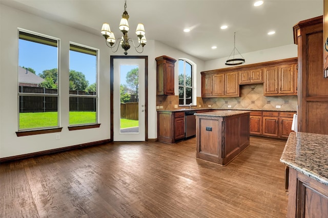 1910 Saint Johns Ave, Allen, TX 75002 - kitchen with stainless steel dishwasher, backsplash, dark wood finished floors, light stone countertops, and a chandelier