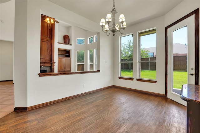 1910 Saint Johns Ave, Allen, TX 75002 - unfurnished dining area with a chandelier and wood finished floors