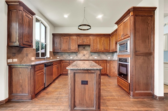 1910 Saint Johns Ave, Allen, TX 75002 - kitchen with appliances with stainless steel finishes, a center island, light wood-style flooring, stone countertops, and recessed lighting
