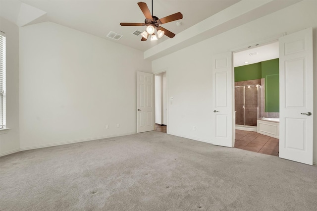 1910 Saint Johns Ave, Allen, TX 75002 - unfurnished bedroom featuring carpet, ensuite bathroom, vaulted ceiling, a ceiling fan, and tile patterned flooring