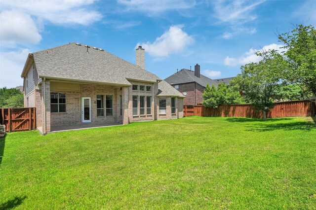 1910 Saint Johns Ave, Allen, TX 75002 - rear view of house featuring brick siding, a fenced backyard, roof with shingles, and a chimney