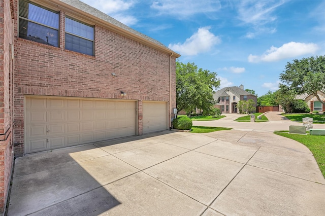 1910 Saint Johns Ave, Allen, TX 75002 - view of side of home with an attached garage, driveway, and brick siding
