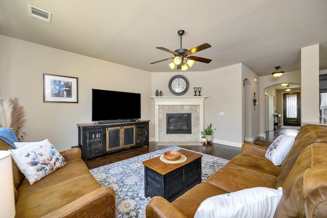 7219 Brisa Rd, Grand Prairie, TX 75054 - living room with ceiling fan, arched walkways, wood finished floors, and a tiled fireplace