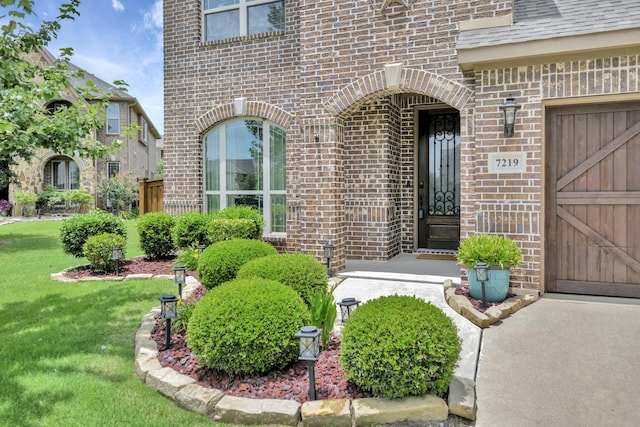 7219 Brisa Rd, Grand Prairie, TX 75054 - entrance to property with brick siding, a yard, and a garage