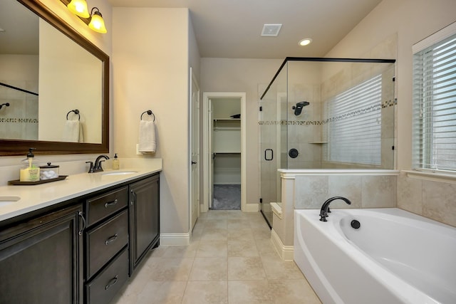 7219 Brisa Rd, Grand Prairie, TX 75054 - full bathroom with a stall shower, a bath, double vanity, tile patterned floors, and a walk in closet