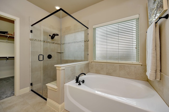 7219 Brisa Rd, Grand Prairie, TX 75054 - bathroom with a bath, a spacious closet, and a stall shower