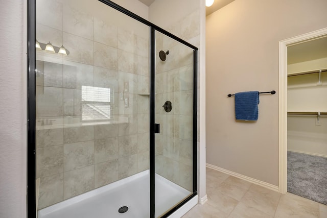7219 Brisa Rd, Grand Prairie, TX 75054 - bathroom featuring a spacious closet, a stall shower, and tile patterned flooring
