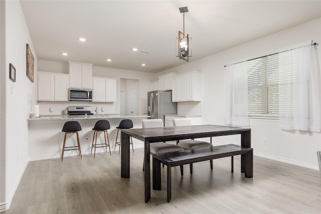 2265 Obsidian Dr, Little Elm, TX 76227 - dining space featuring light wood-style floors, recessed lighting, and a chandelier
