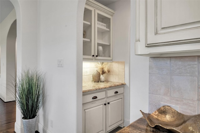 1400 Lakeside Dr, Prosper, TX 75078 - bar featuring arched walkways, decorative backsplash, and dark wood-type flooring