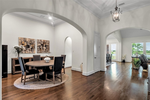 1400 Lakeside Dr, Prosper, TX 75078 - dining area featuring a high ceiling, crown molding, arched walkways, dark wood finished floors, and a chandelier