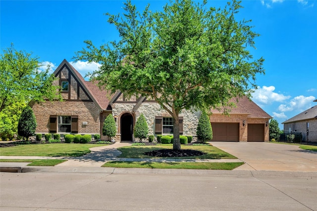 1400 Lakeside Dr, Prosper, TX 75078 - view of front facade with stone siding, driveway, and a garage