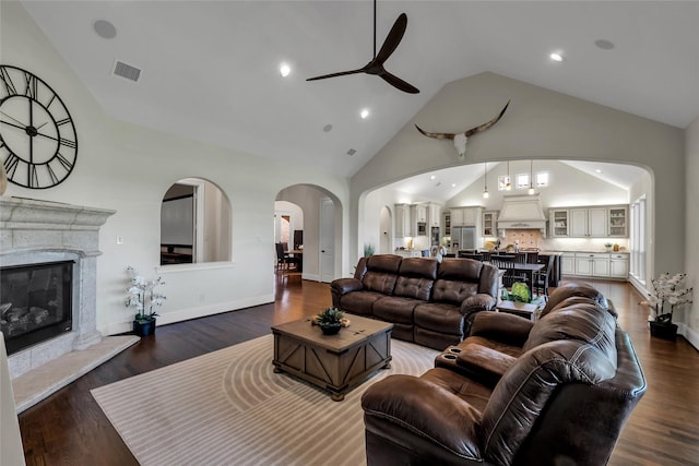 1400 Lakeside Dr, Prosper, TX 75078 - living room featuring ceiling fan, arched walkways, high vaulted ceiling, wood finished floors, and a premium fireplace