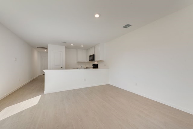 1657 Crested Way, Fort Worth, TX 76140 - unfurnished living room featuring recessed lighting and light wood-style flooring