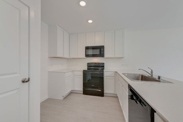 1657 Crested Way, Fort Worth, TX 76140 - kitchen with black appliances, white cabinets, light countertops, light wood-style flooring, and recessed lighting