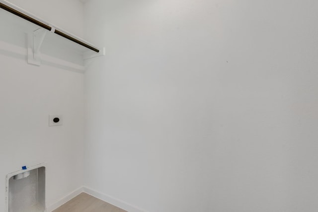 1657 Crested Way, Fort Worth, TX 76140 - washroom featuring hookup for an electric dryer and light wood-type flooring