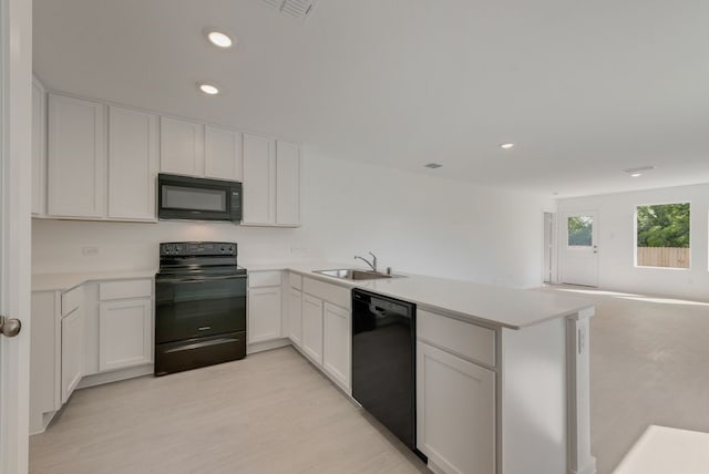 1657 Crested Way, Fort Worth, TX 76140 - kitchen featuring black appliances, a peninsula, recessed lighting, light countertops, and open floor plan