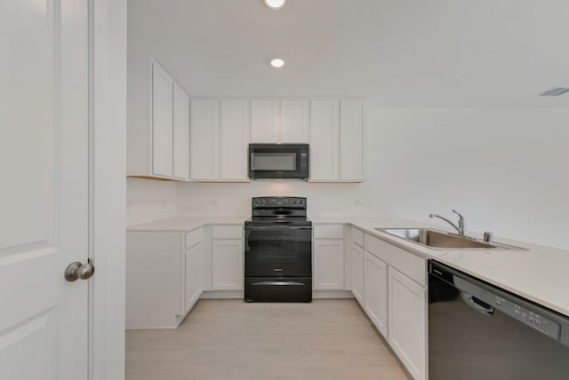 1657 Crested Way, Fort Worth, TX 76140 - kitchen with black appliances, white cabinetry, light countertops, recessed lighting, and light wood-style floors