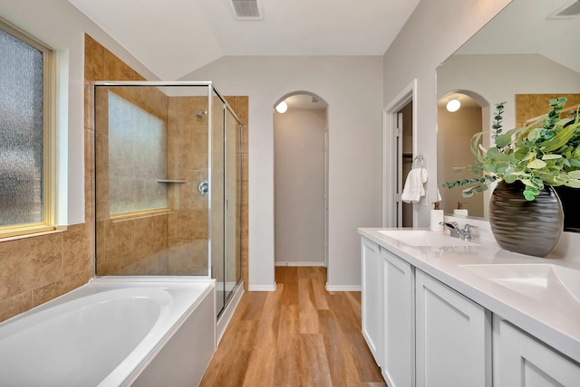 5361 Brentlawn Dr, Fort Worth, TX 76179 - bathroom with a shower stall, lofted ceiling, a garden tub, double vanity, and wood finished floors