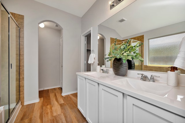 5361 Brentlawn Dr, Fort Worth, TX 76179 - full bathroom with a shower stall, double vanity, wood finished floors, and vaulted ceiling