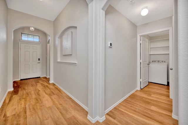 5361 Brentlawn Dr, Fort Worth, TX 76179 - foyer entrance with arched walkways, washer / clothes dryer, and light wood-style flooring
