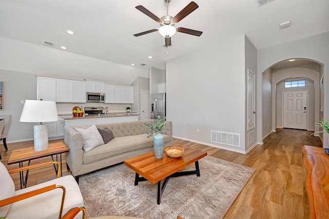 5361 Brentlawn Dr, Fort Worth, TX 76179 - living room featuring arched walkways, a ceiling fan, vaulted ceiling, light wood-type flooring, and recessed lighting