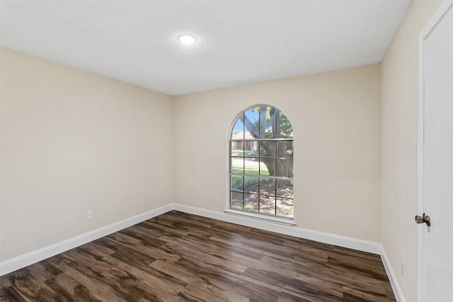 1037 Alicia Ln, Lancaster, TX 75134 - spare room featuring dark wood-type flooring, recessed lighting, and a textured ceiling